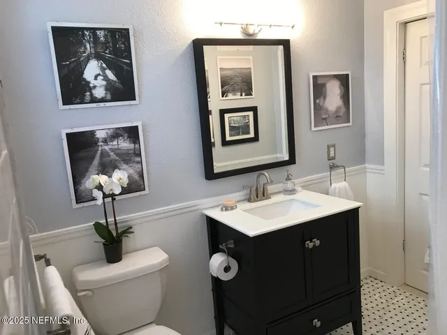 a bathroom with a toilet a sink and mirror