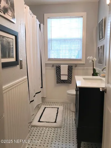 a bathroom with a sink a toilet and a mirror