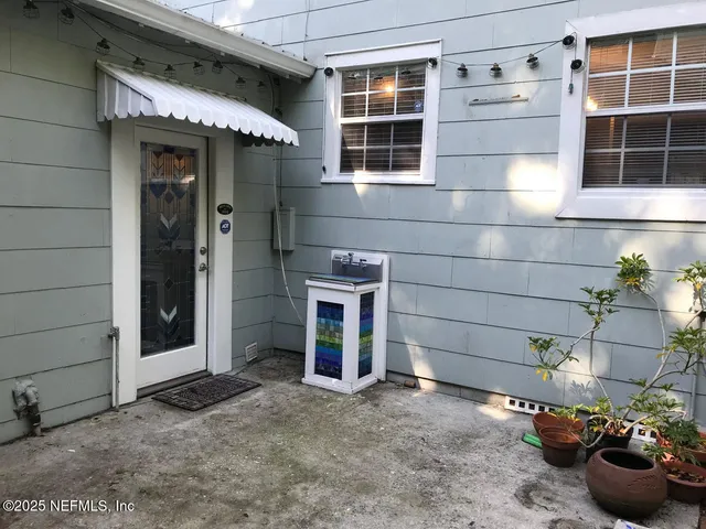 a view of a house with a potted plant and a window