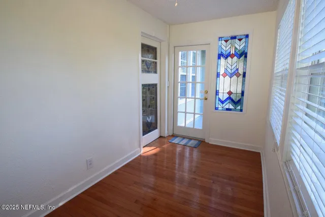 a view of an entryway with wooden floor