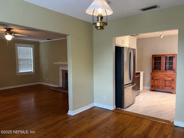 a view of livingroom with hardwood floor and a kitchen