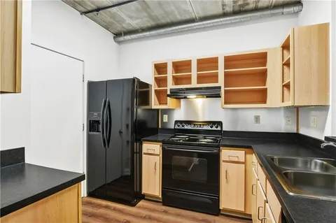 a kitchen with stainless steel appliances granite countertop a sink stove and cabinets