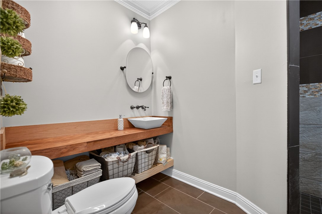 206 James Hare Road Anderson, SC 29626 - Photo 21 of 37 A well-appointed lavatory boasts a modern vessel sink set atop a sleek wooden vanity with convenient open storage beneath.
