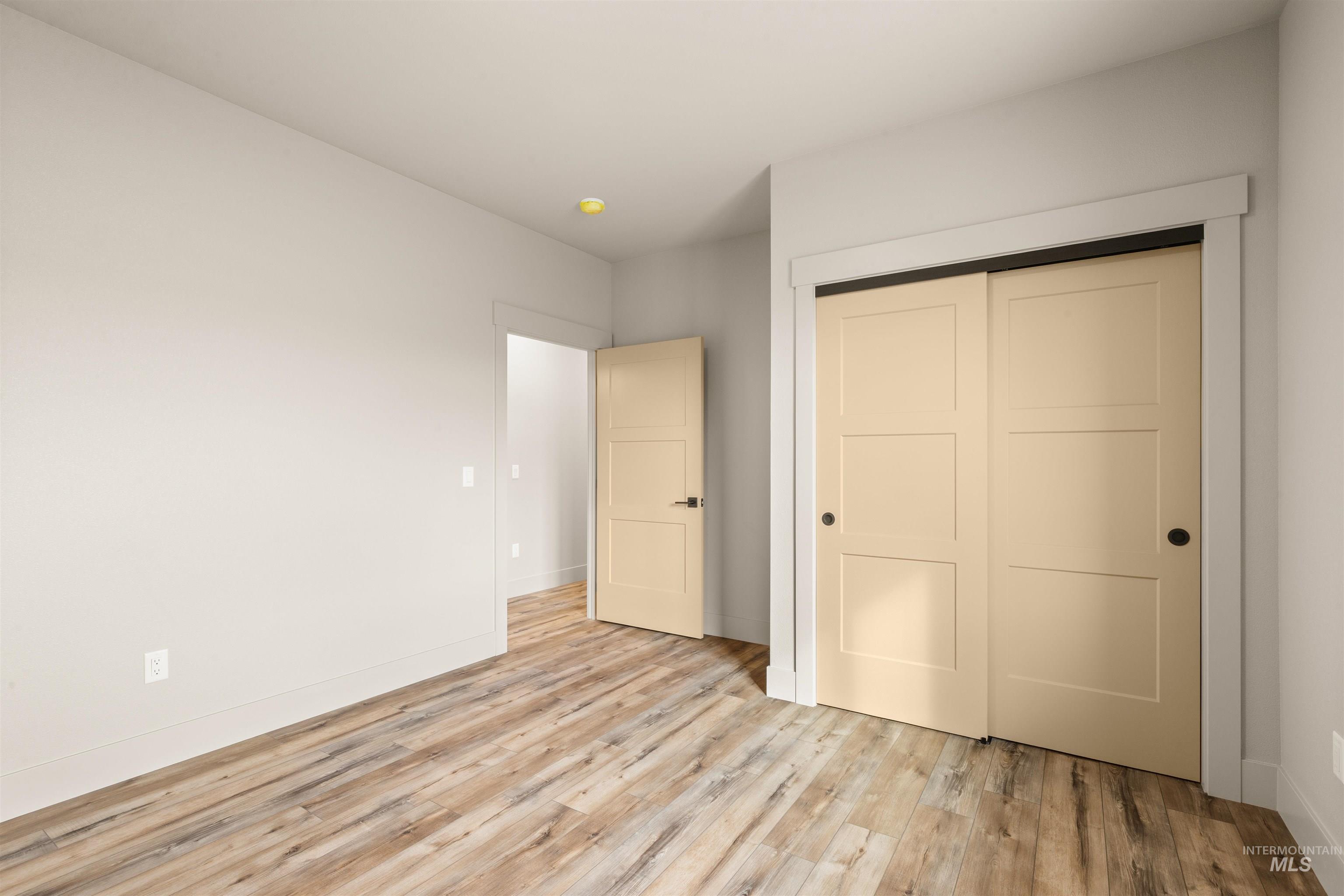 335 Warner Avenue Lewiston, ID 83501 - Photo 34 of 43 Unfurnished bedroom with light wood-style flooring and a closet