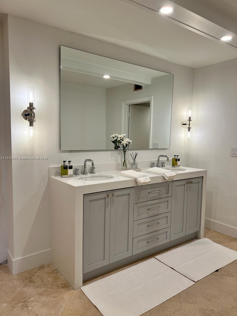 a bathroom with a sink vanity and mirror