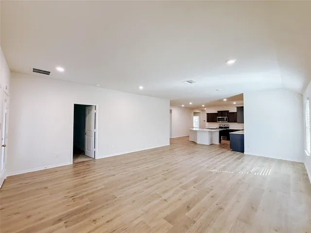 a view of a kitchen with a sink and a refrigerator