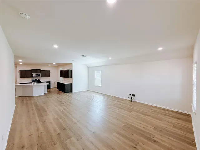 a view of a kitchen with microwave and cabinets