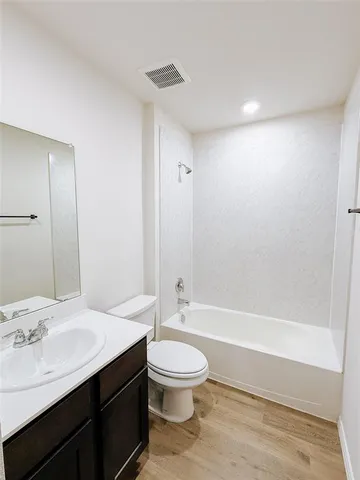a bathroom with a sink a toilet and a large mirror