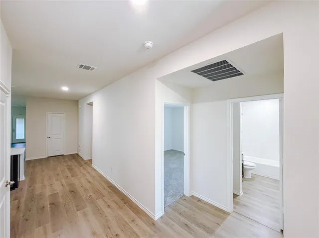 a view of hallway with wooden floor