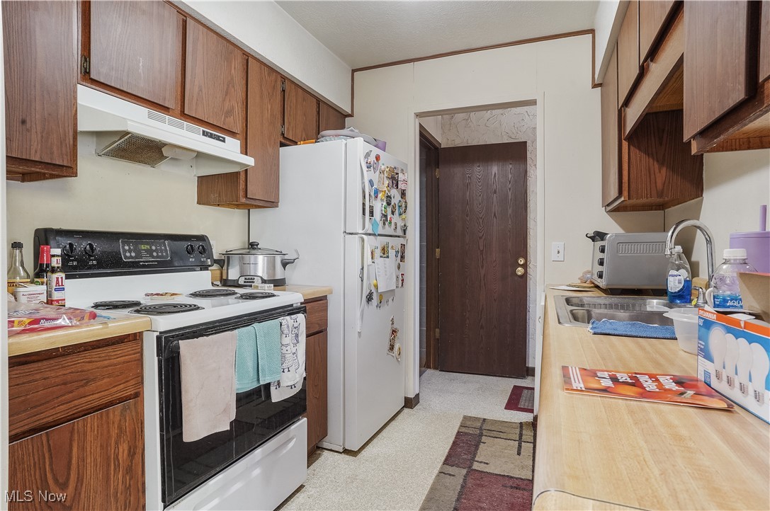 944 Pheasant Run Road Akron, OH 44305 - Photo 6 of 14 Kitchen featuring sink and white appliances