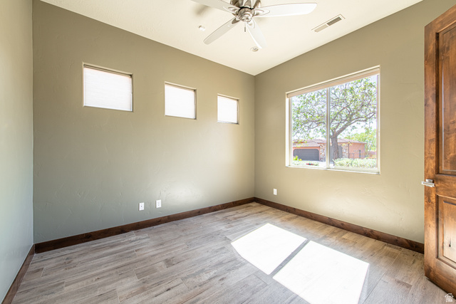322 340 E Street Ivins, UT 84738 - Photo 42 of 61 Spacious room featuring wood-finish flooring, a ceiling fan, and multiple windows for natural illumination