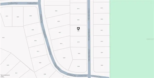 a view of a forest with trees in the background