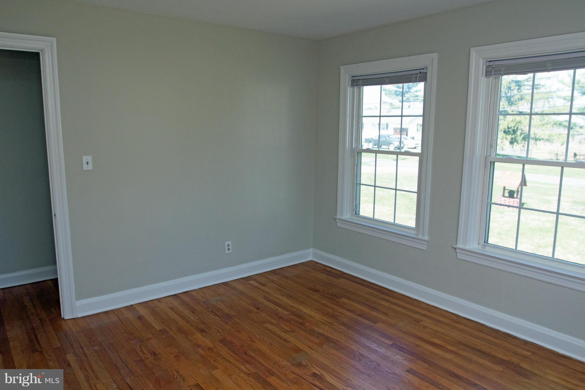 5303 Glen Falls Road Reisterstown, MD 21136 - Photo 12 of 30 an empty room with wooden floor and windows