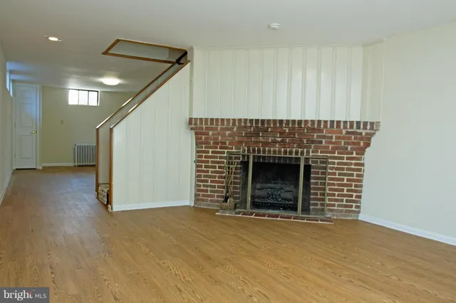 a view of an empty room with a fireplace