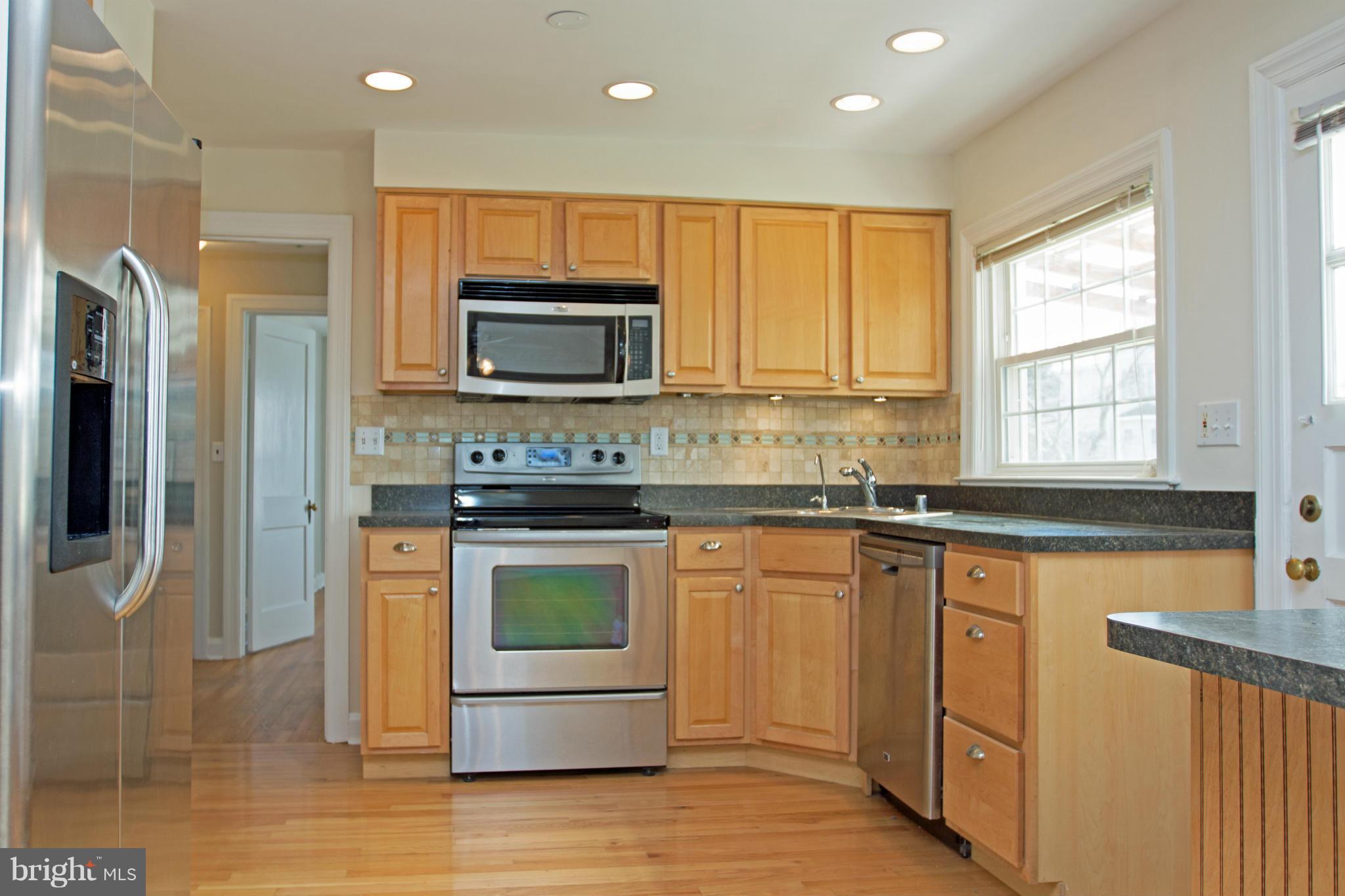 5303 Glen Falls Road Reisterstown, MD 21136 - Photo 2 of 30 a kitchen with granite countertop a stove top oven and sink