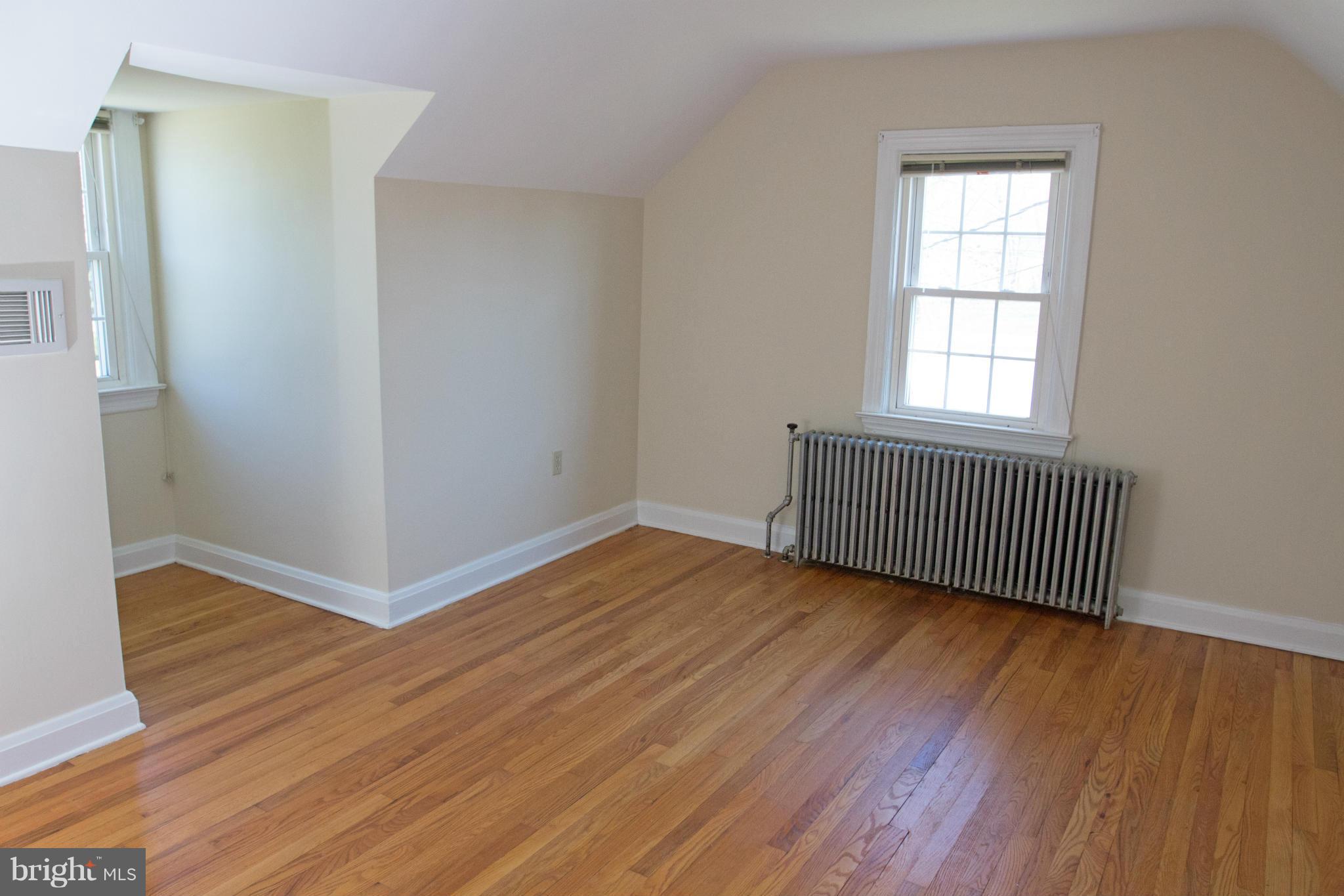 5303 Glen Falls Road Reisterstown, MD 21136 - Photo 21 of 30 an empty room with wooden floor and windows
