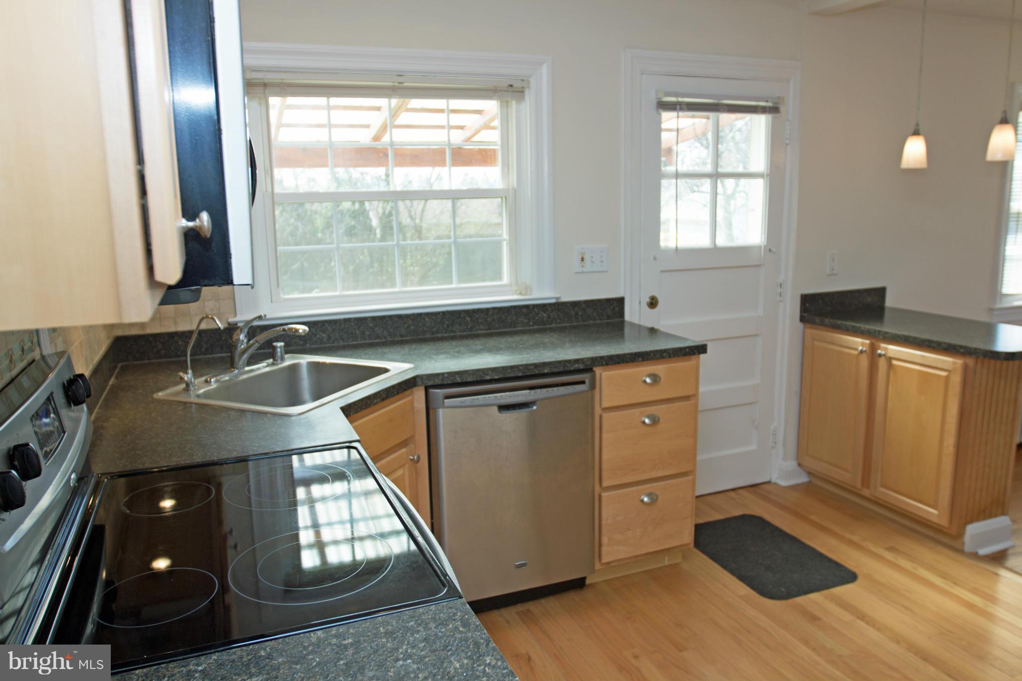 5303 Glen Falls Road Reisterstown, MD 21136 - Photo 3 of 30 a kitchen with granite countertop a sink stove and cabinets