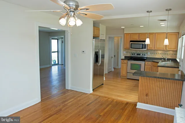 a view of a kitchen from the hallway