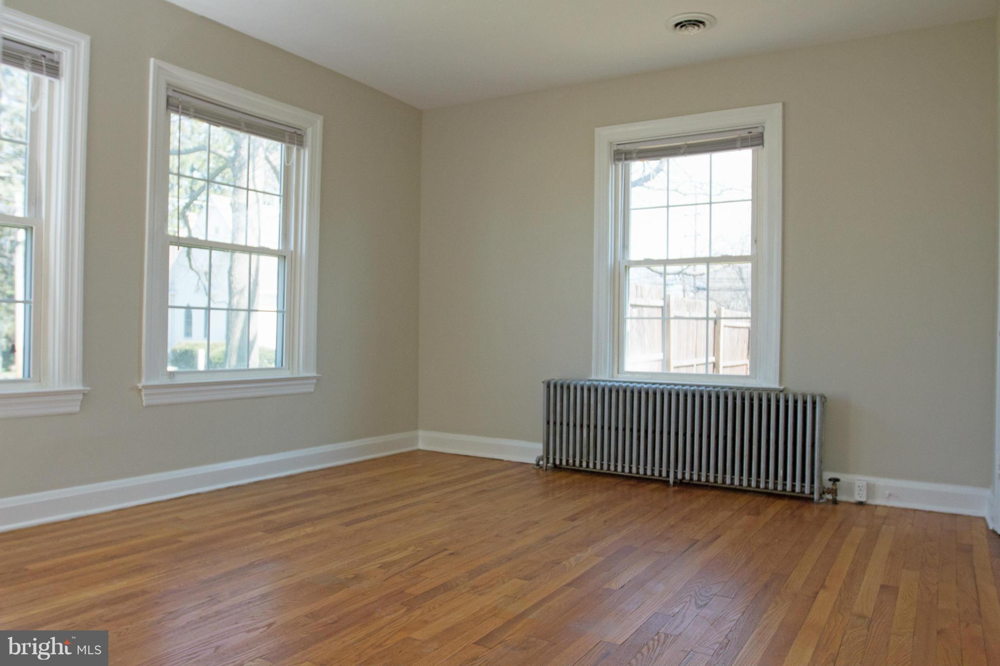 5303 Glen Falls Road Reisterstown, MD 21136 - Photo 9 of 30 an empty room with wooden floor and windows