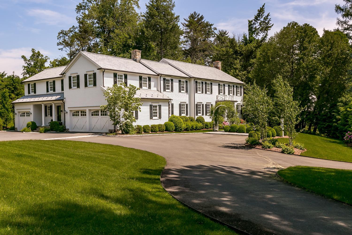 94 Marshall Ridge Road New Canaan, CT 06840 - Photo 1 of 50 a front view of a house with a garden