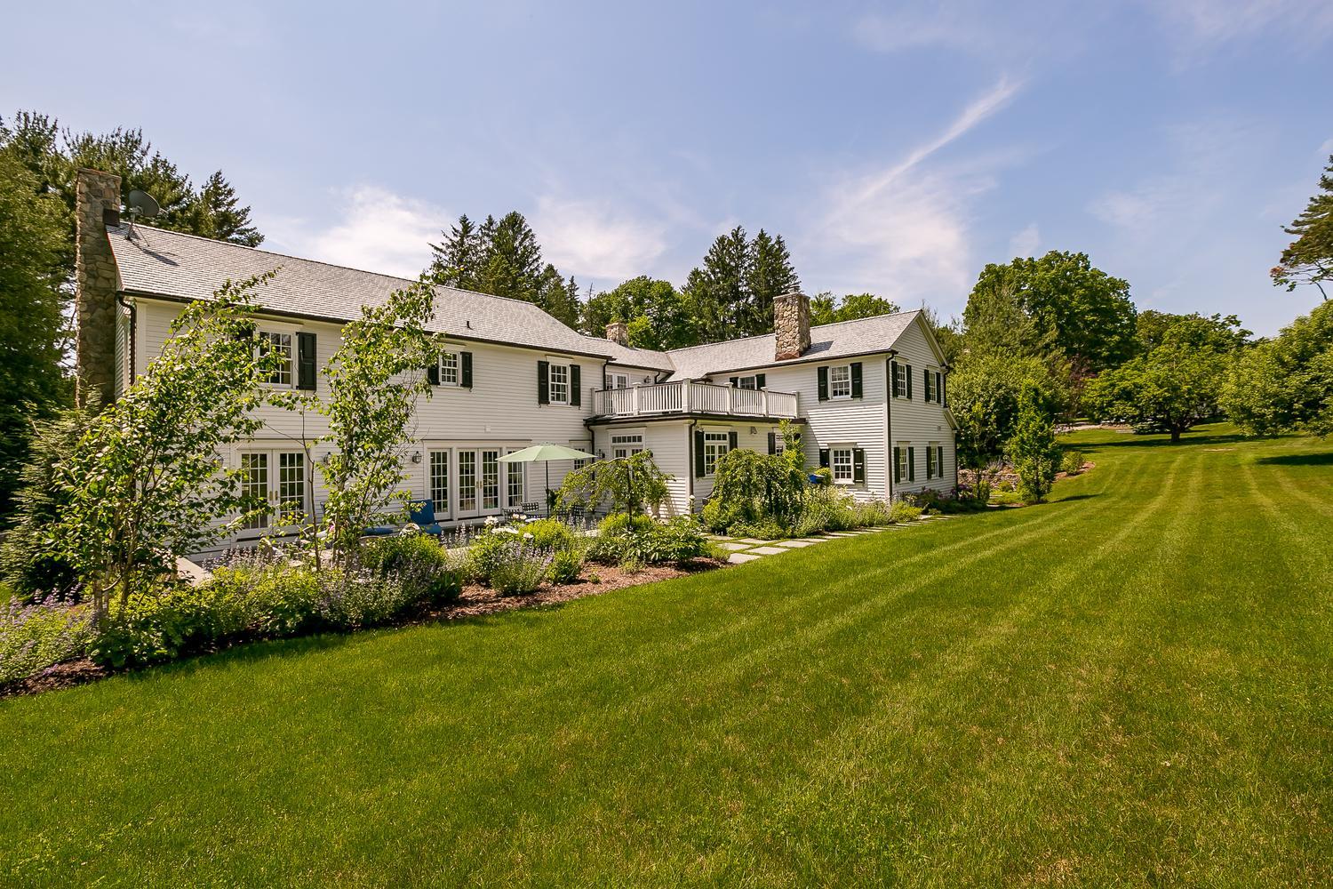 94 Marshall Ridge Road New Canaan, CT 06840 - Photo 40 of 50 a front view of a house with garden