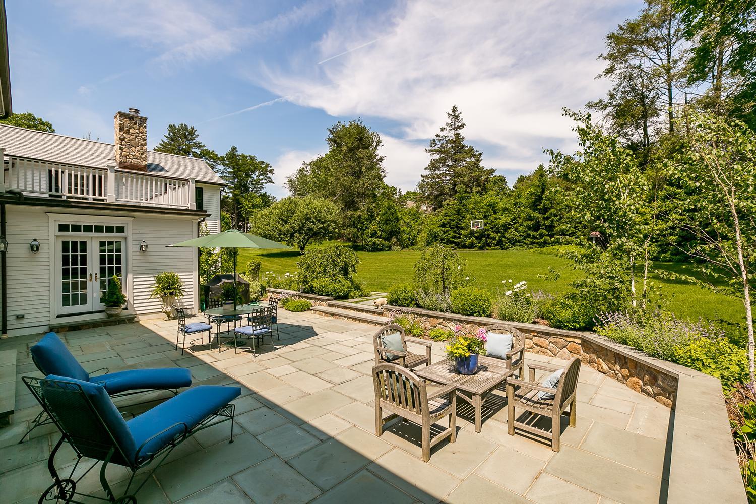 94 Marshall Ridge Road New Canaan, CT 06840 - Photo 45 of 50 a view of a patio with couches table and chairs with wooden floor and fence