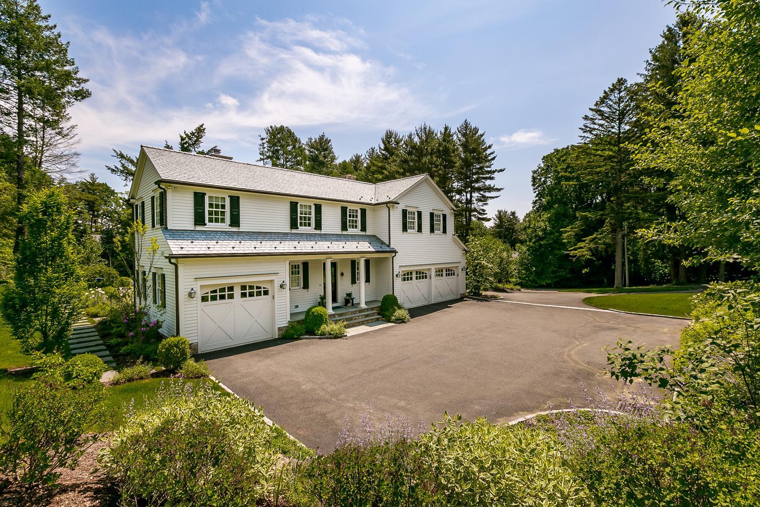 94 Marshall Ridge Road New Canaan, CT 06840 - Photo 47 of 50 a front view of a house with a yard and trees