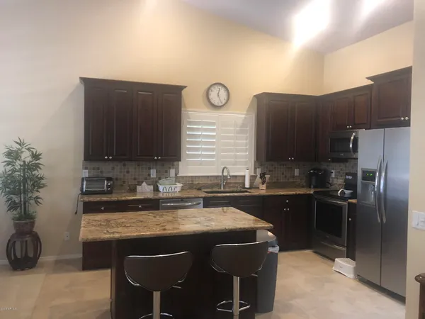 a kitchen with a sink cabinets and stainless steel appliances