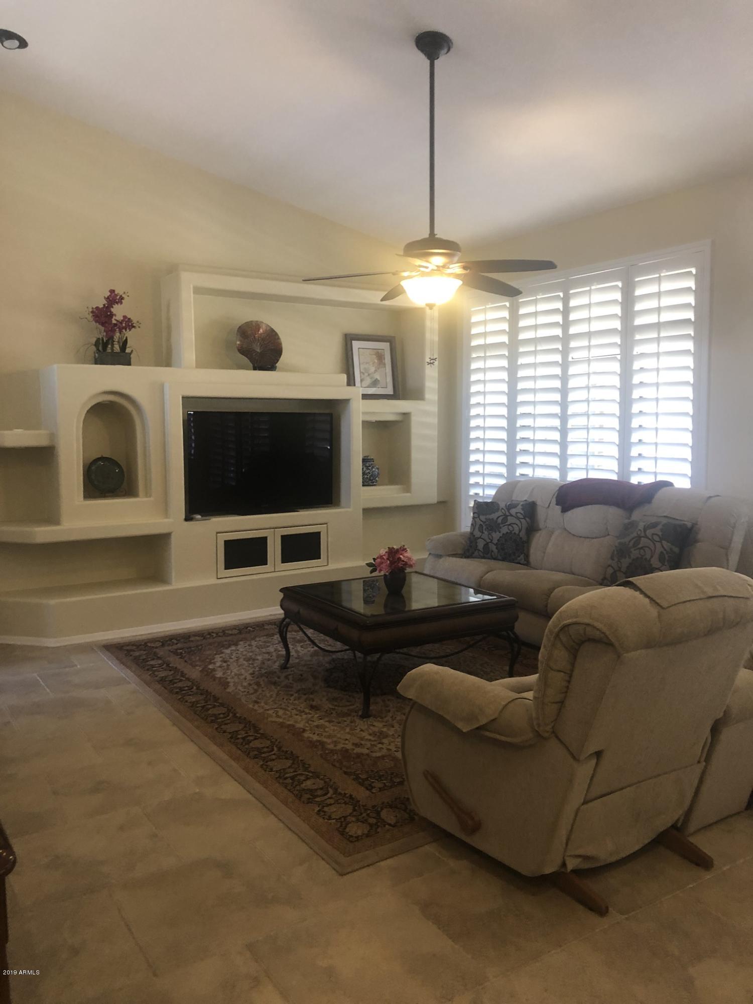 3923 North 151st Avenue Goodyear, AZ 85395 - Photo 6 of 22 a living room with furniture and a flat screen tv