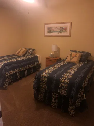 a bed sitting in a bedroom next to a lamp