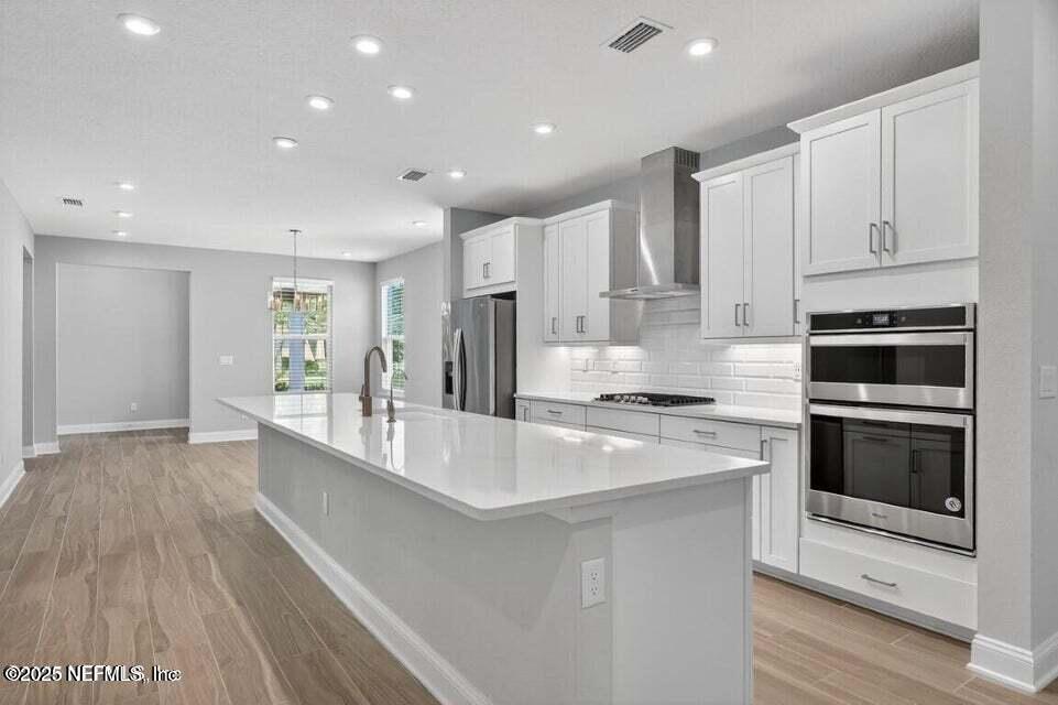 97 Kellet Way St. Johns, FL 32259 - Photo 8 of 23 a large kitchen with stainless steel appliances granite countertop a stove a sink and a refrigerator