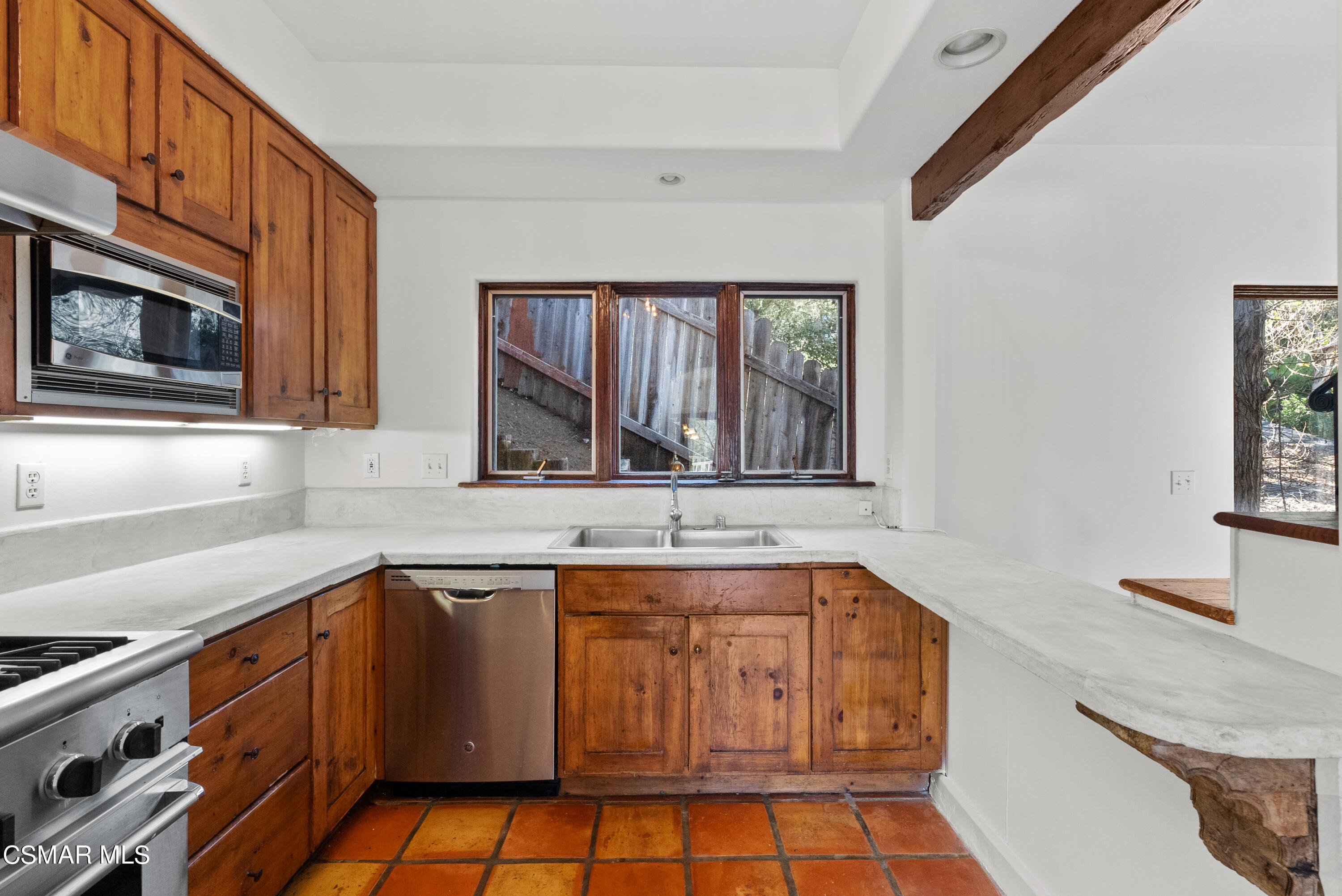 2045 Lookout Drive Agoura Hills, CA 91301 - Photo 7 of 34 a kitchen with stainless steel appliances granite countertop a sink stove and cabinets