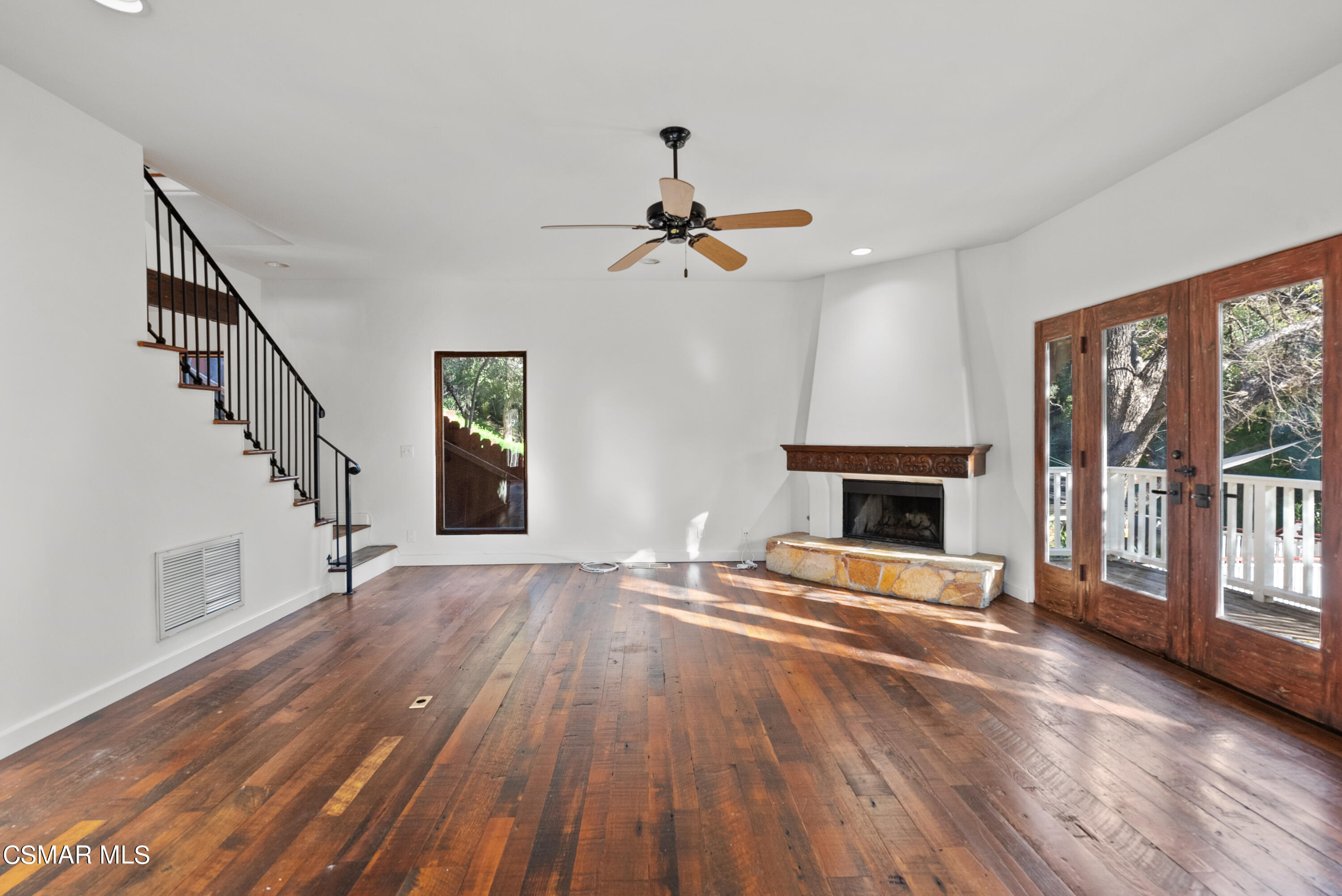 2045 Lookout Drive Agoura Hills, CA 91301 - Photo 9 of 34 a view of an empty room with wooden floor fireplace and a window