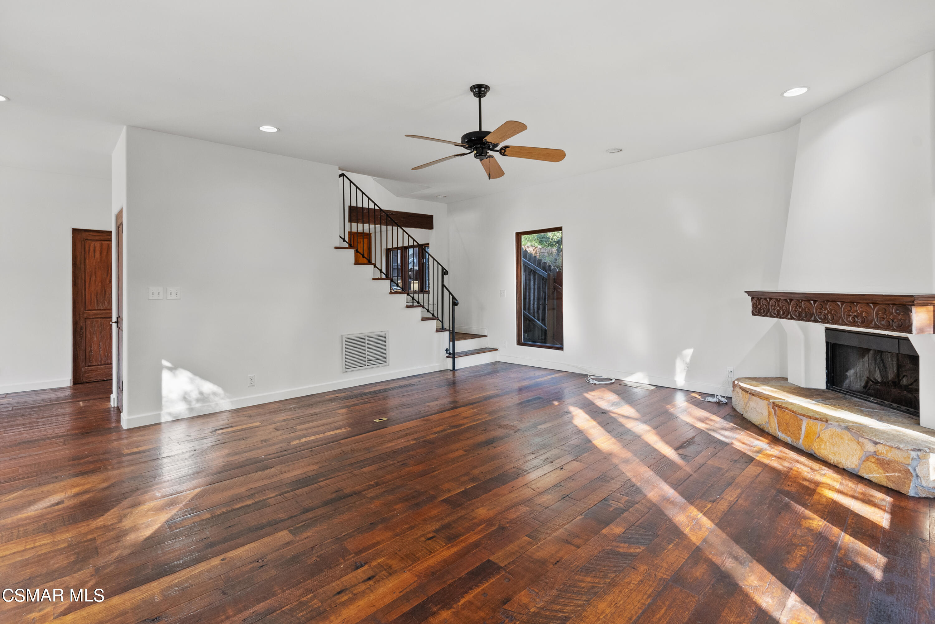 2045 Lookout Drive Agoura Hills, CA 91301 - Photo 10 of 34 a view of a livingroom with wooden floor and a ceiling fan