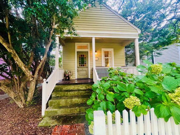 a front view of a house with a garden