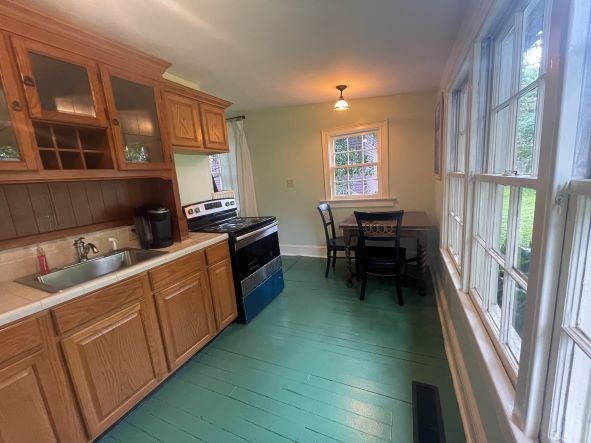 212 West 7th Street Columbus, GA 31901 - Photo 13 of 20 a kitchen with sink cabinets and wooden floor