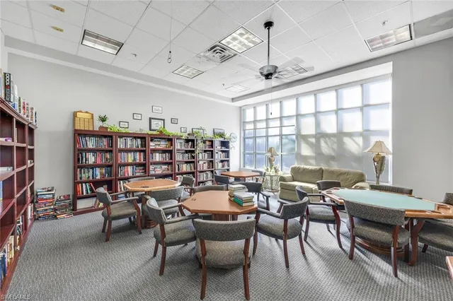 a dining room with furniture water view and a large window