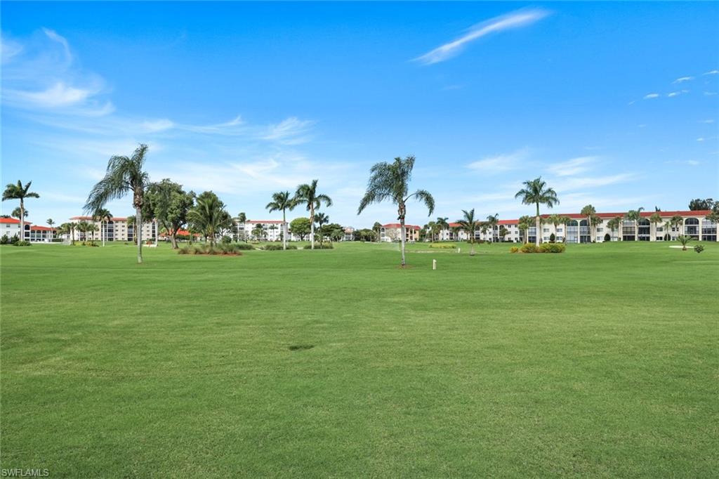 37 High Point Circle East, Unit 109 Naples, FL 34103 - Photo 35 of 37 a view of a field with grass and trees