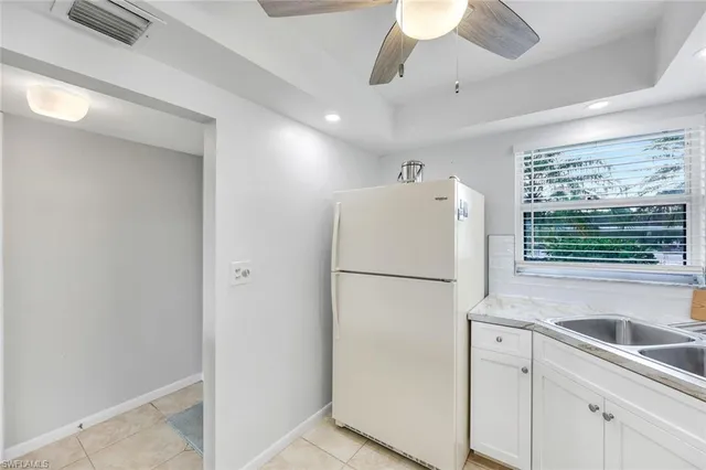 a white refrigerator freezer sitting inside of a kitchen
