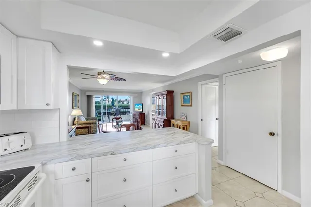 a kitchen with counter top space cabinets and a window