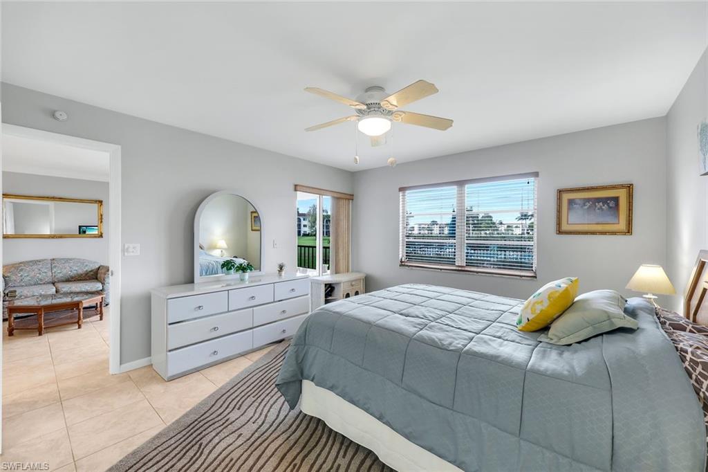 37 High Point Circle East, Unit 109 Naples, FL 34103 - Photo 10 of 37 a bedroom with a bed and a window