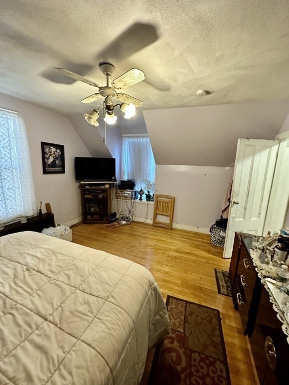 4 Glendale Place Everett, MA 02149 - Photo 11 of 14 a bedroom with a bed and a flat screen tv