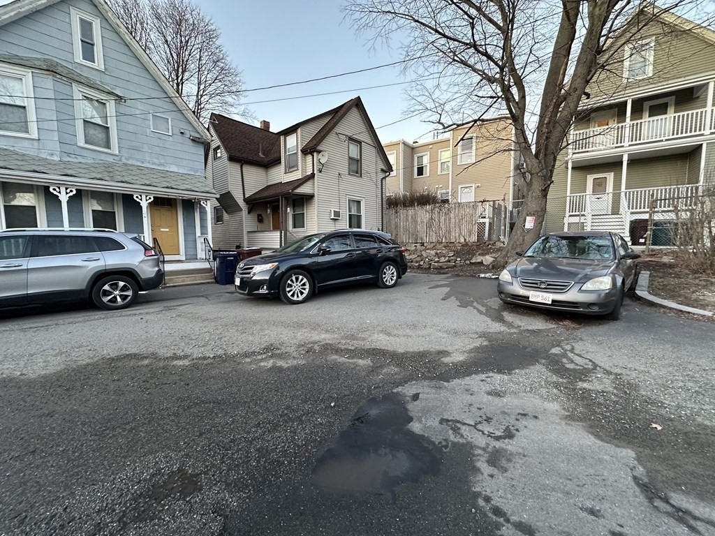 4 Glendale Place Everett, MA 02149 - Photo 14 of 14 a car parked in front of a white house