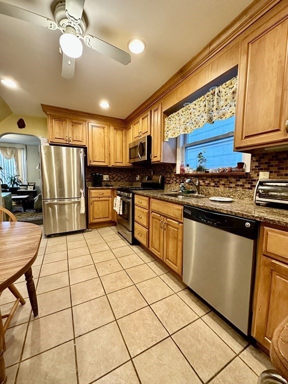4 Glendale Place Everett, MA 02149 - Photo 4 of 14 a kitchen with stainless steel appliances granite countertop a stove a sink dishwasher a refrigerator and cabinets with wooden floor