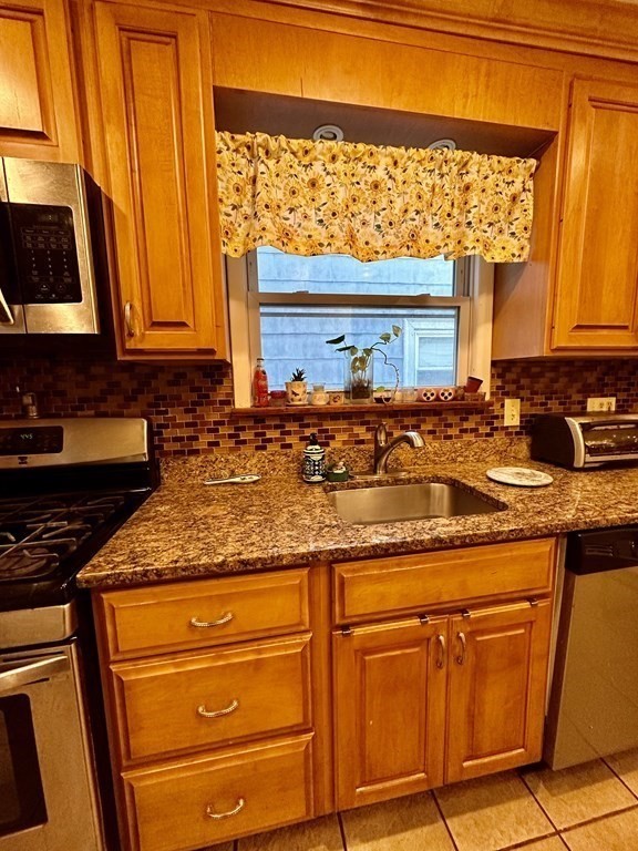 4 Glendale Place Everett, MA 02149 - Photo 5 of 14 a kitchen with granite countertop cabinets stainless steel appliances and a sink