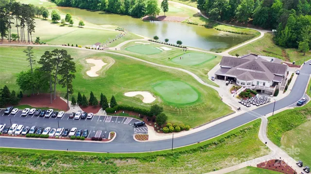 an aerial view of a house with yard swimming pool and outdoor seating