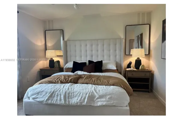 a bedroom with a bed and a mirror