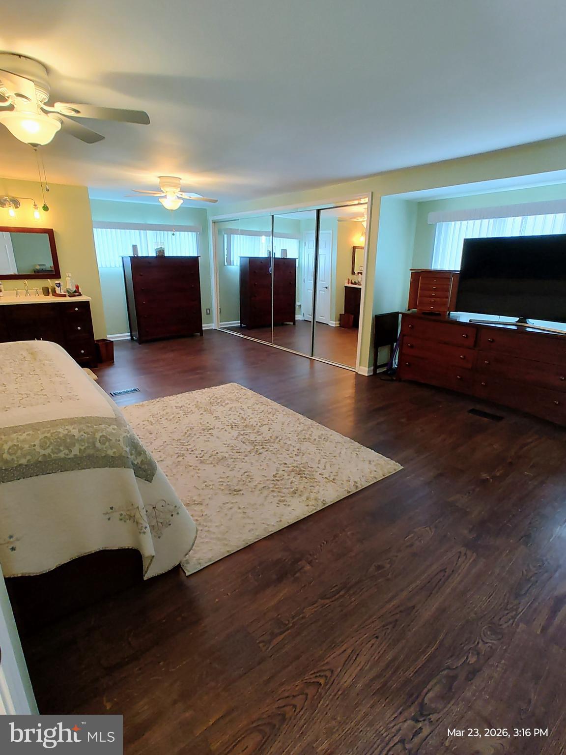 4728 Bucks School House Road Baltimore, MD 21237 - Photo 19 of 64 a spacious bedroom with a bed and wooden floor