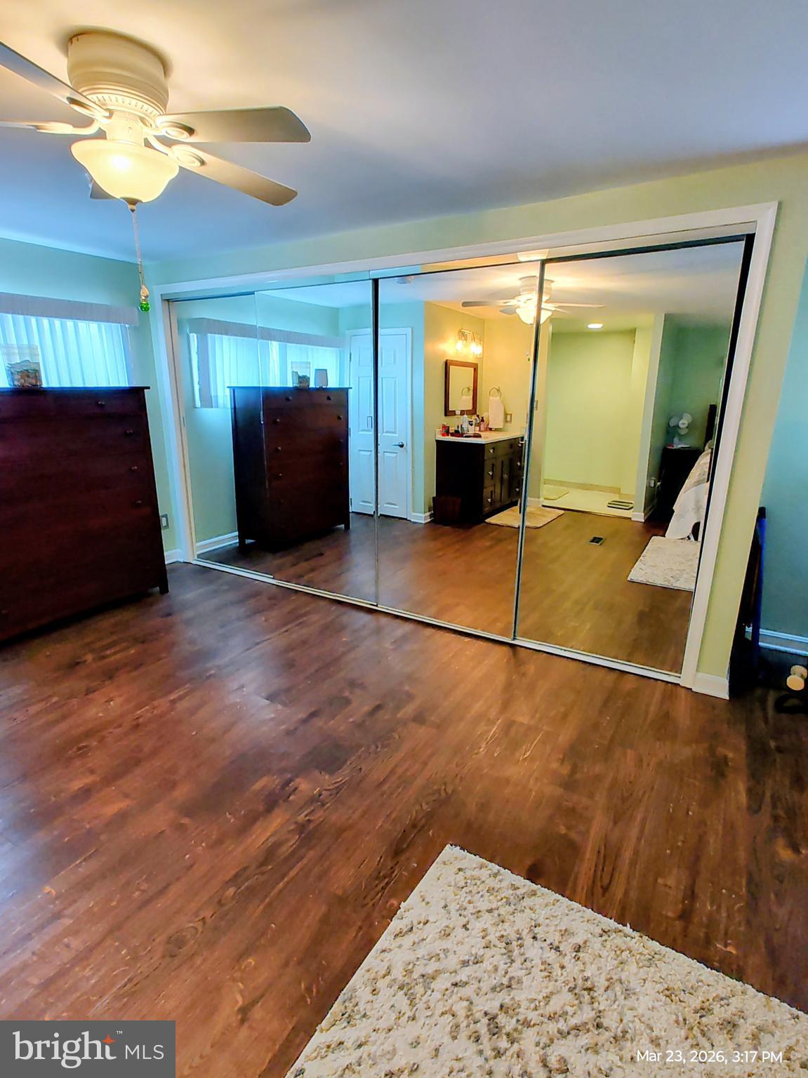 4728 Bucks School House Road Baltimore, MD 21237 - Photo 20 of 64 a view of a livingroom with wooden floor and a ceiling fan
