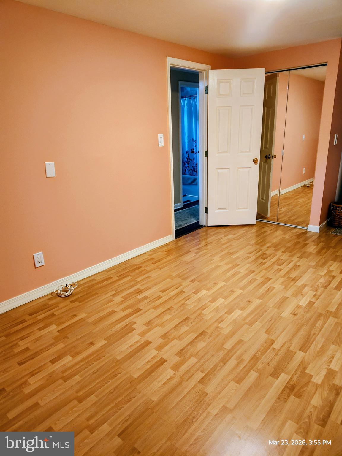 4728 Bucks School House Road Baltimore, MD 21237 - Photo 28 of 64 a view of an empty room with wooden floor and a window